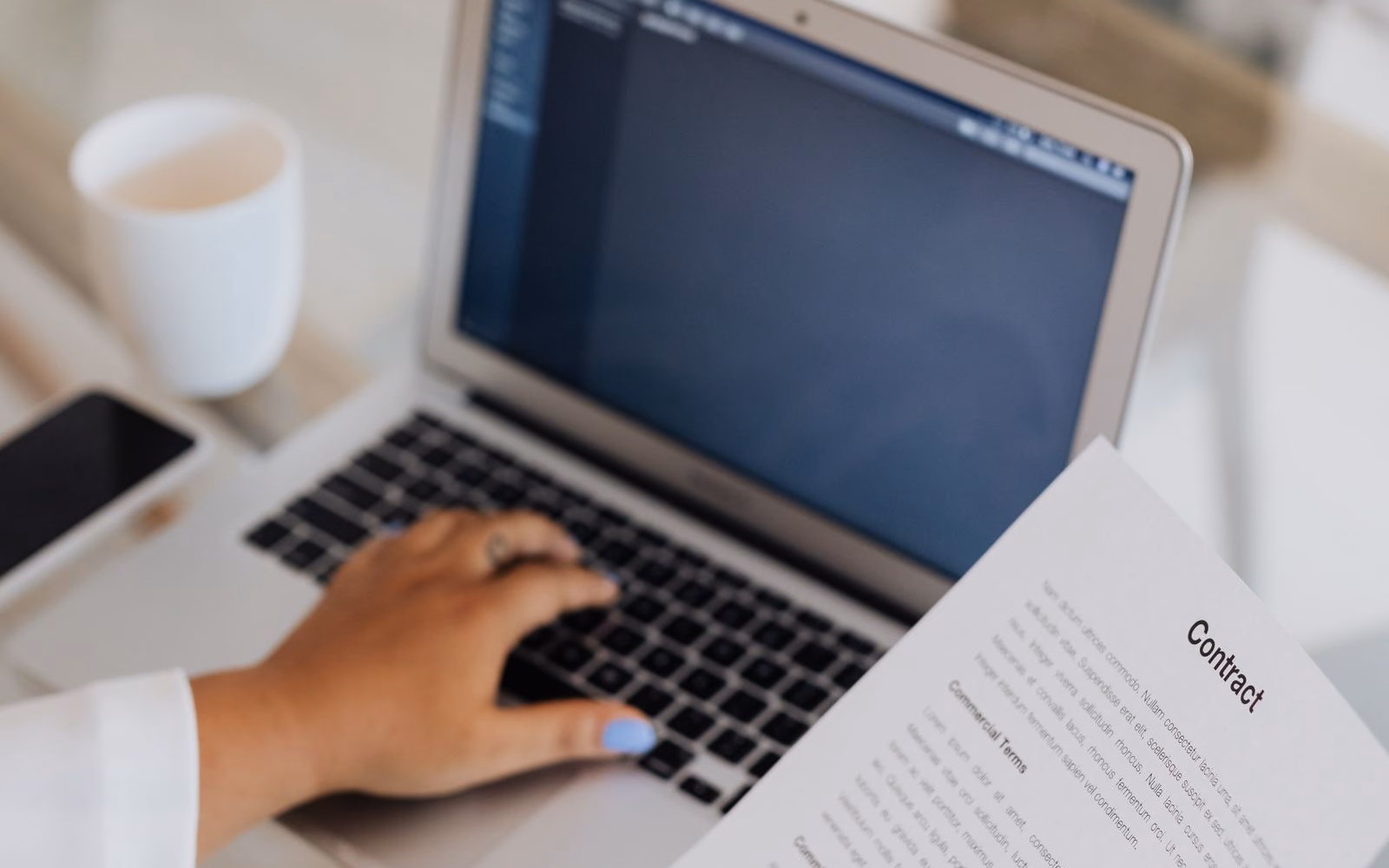 Contract and laptop used for digital quote follow-up