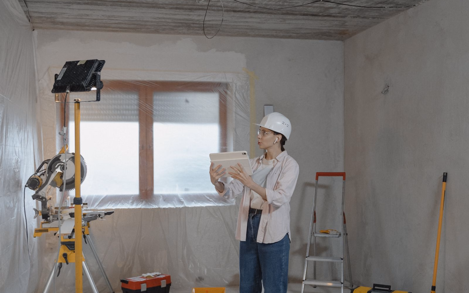 Tradesperson using a tablet on a residential job site